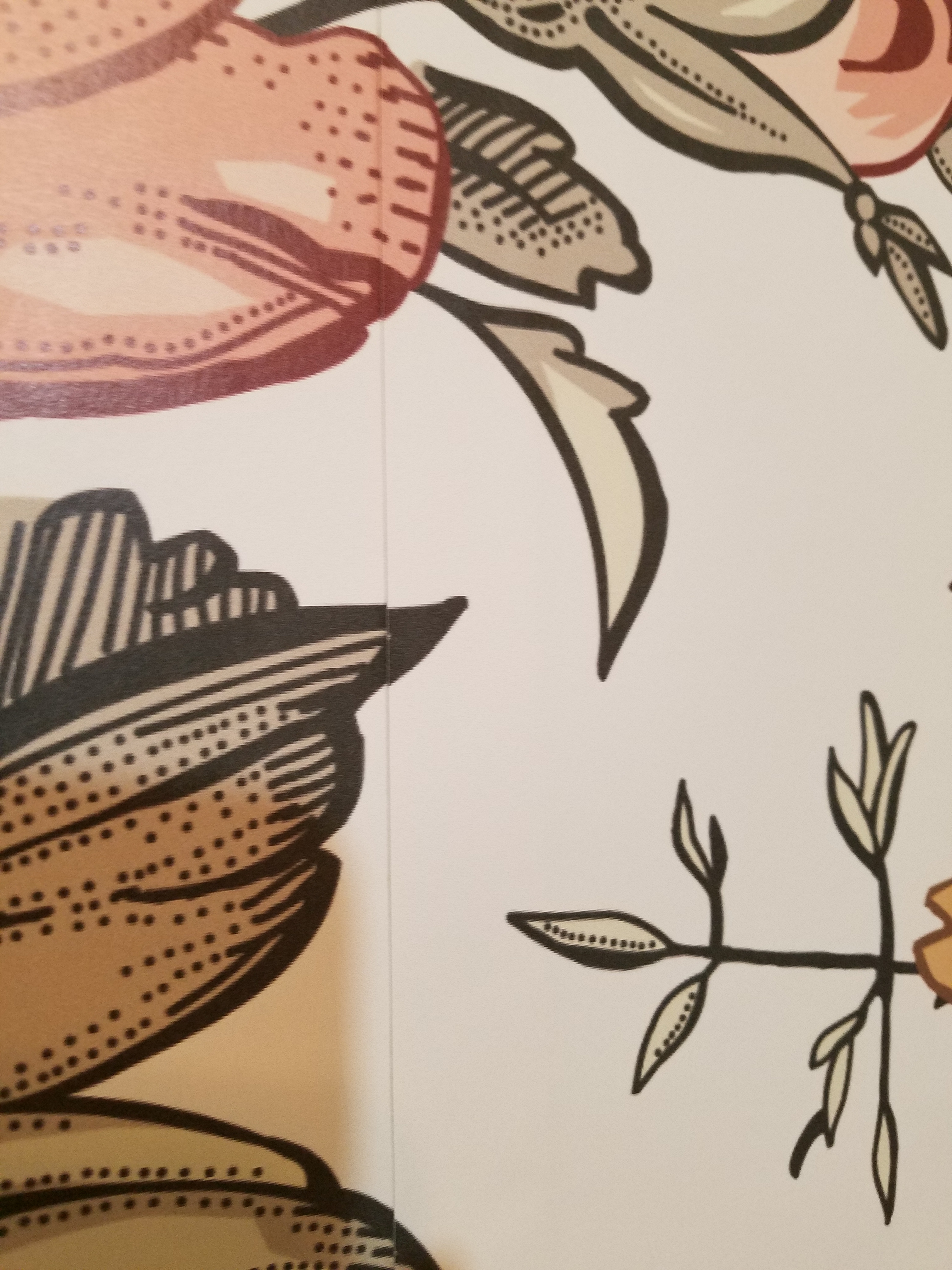 Installer smoothing a wallpaper seam with a professional tool